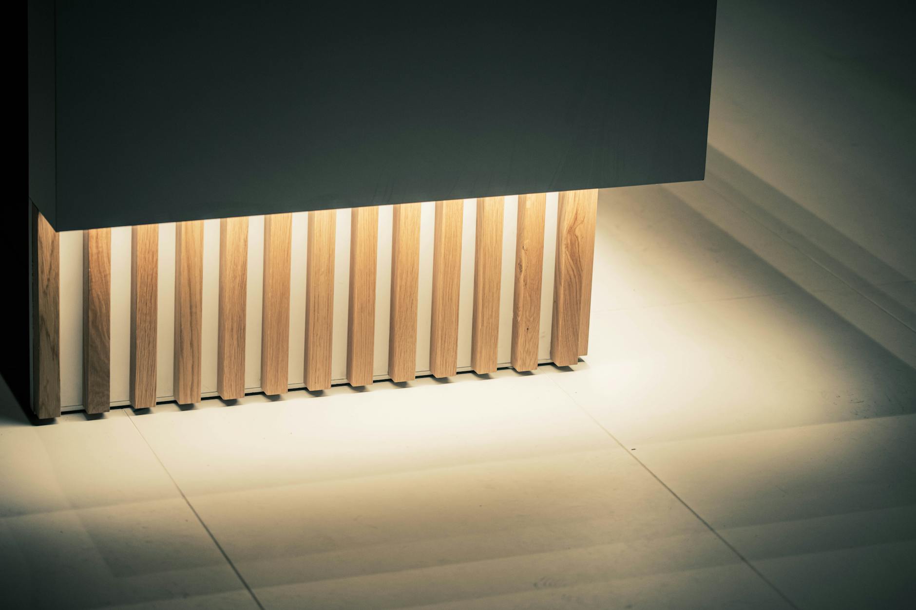 Elegant architectural element featuring illuminated wooden slats against a sleek paneling. Ideal for contemporary design concepts.