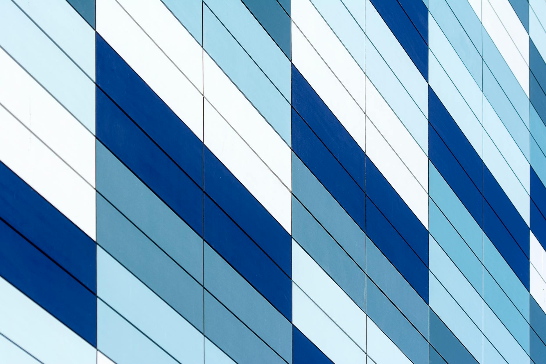 A striking modern facade with a blue and white geometric design, showcasing urban architecture.