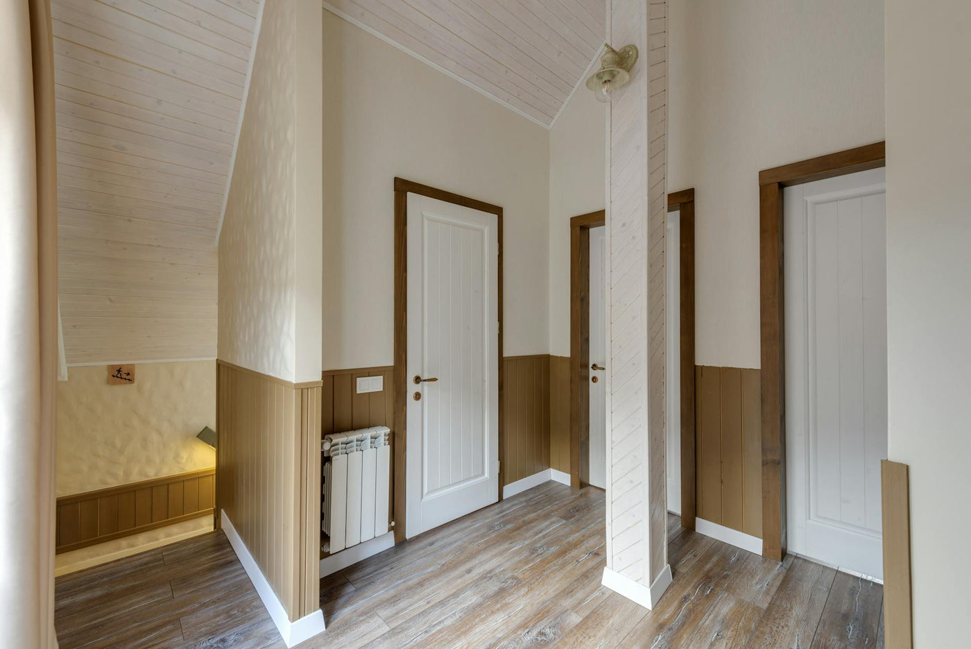 Empty hallway in a modern chalet with wooden doors and elegant design.