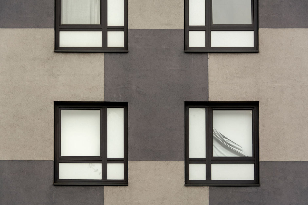 Geometric facade featuring symmetrical windows on a modern building.