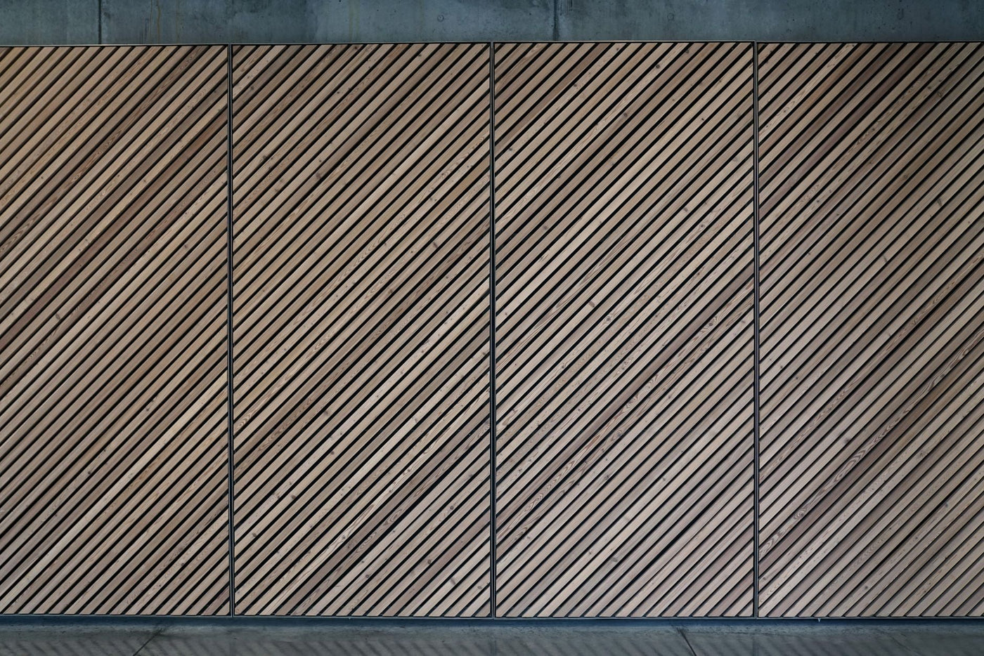 Abstract view of a diagonal wooden panel wall with a textured, patterned design.
