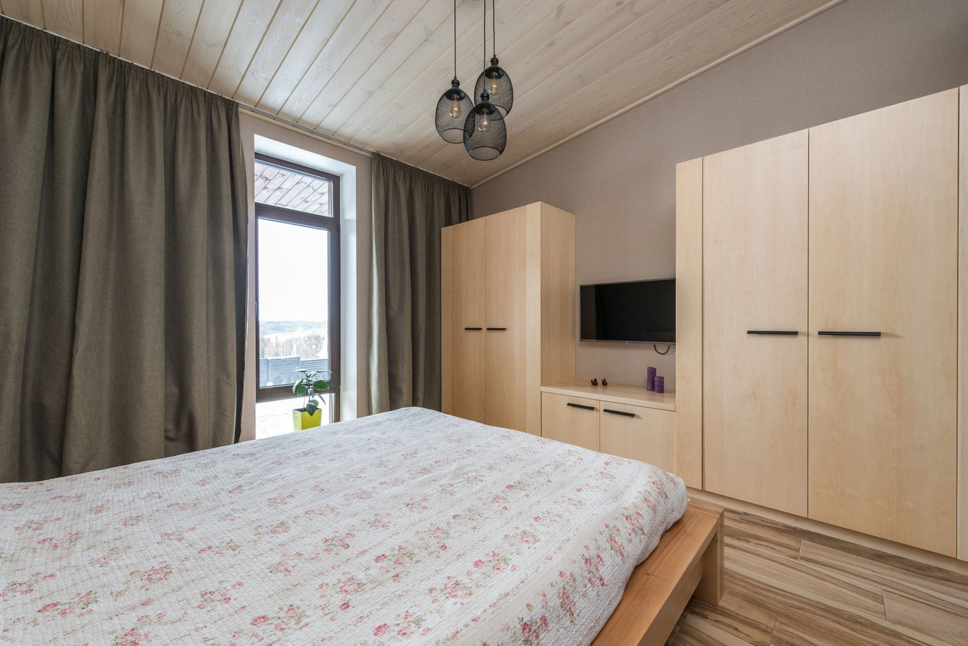 Inviting bedroom showcasing modern interior design with warm wooden elements and natural light.