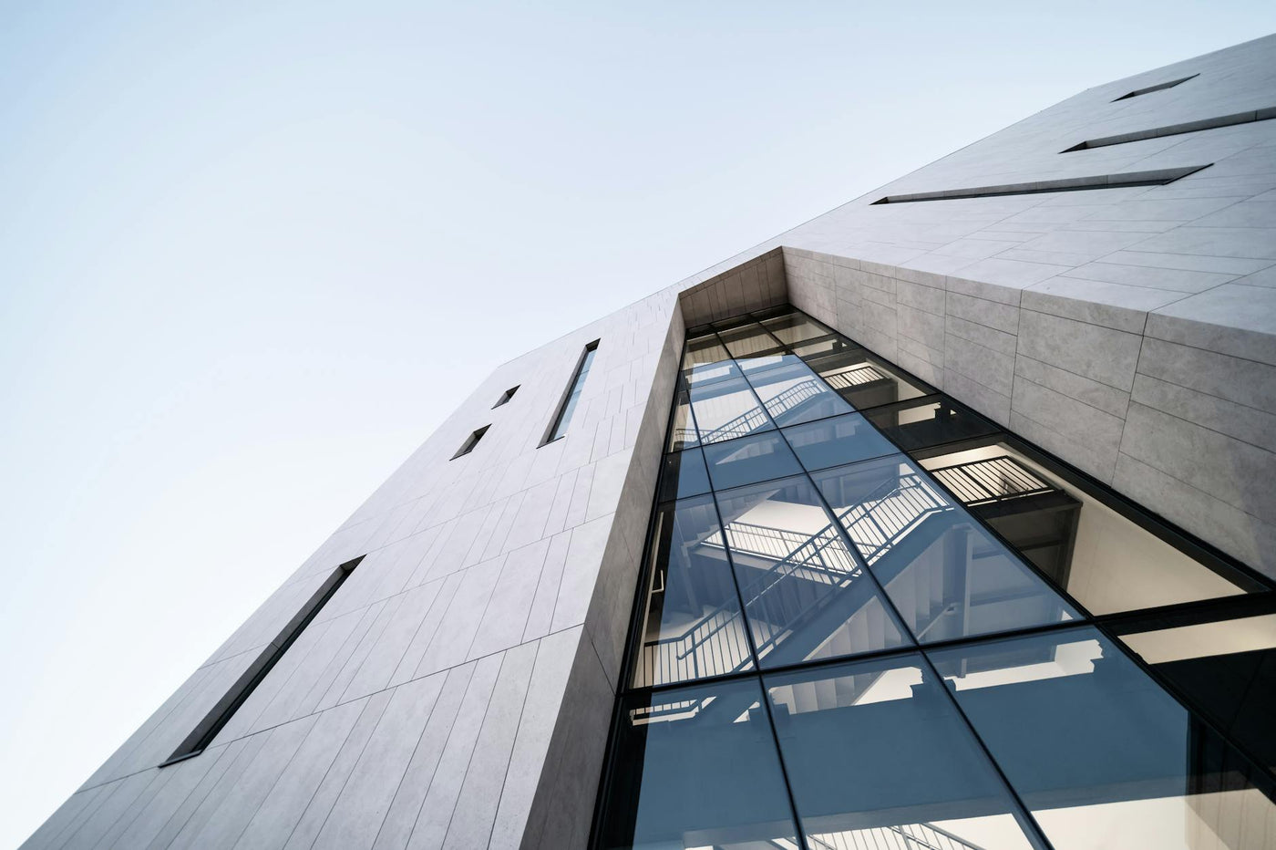 From below of contemporary multistage house exterior with staircases inside under sky in town