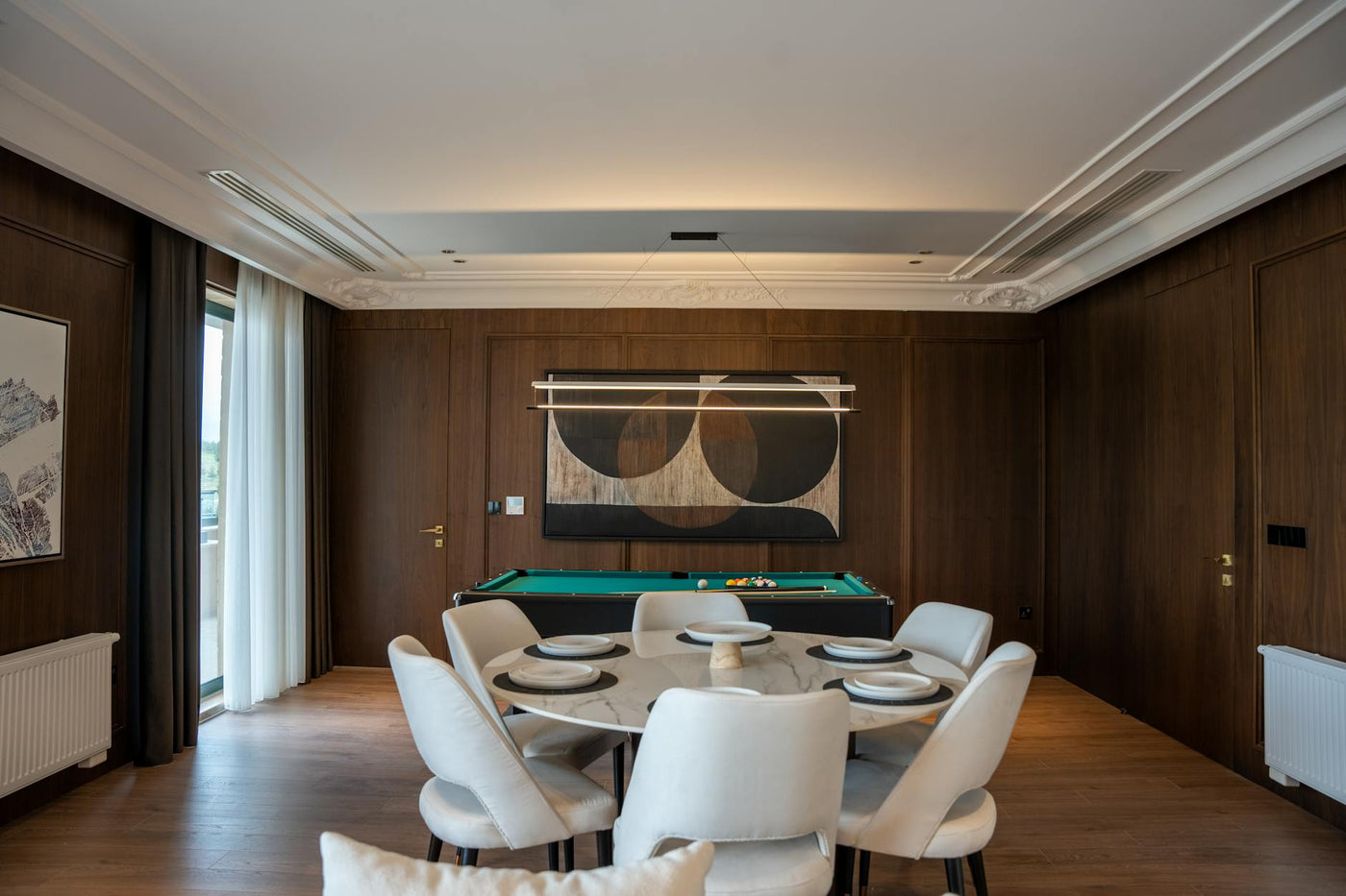 Contemporary dining room featuring a billiard table and minimalist decor for a luxurious feel.