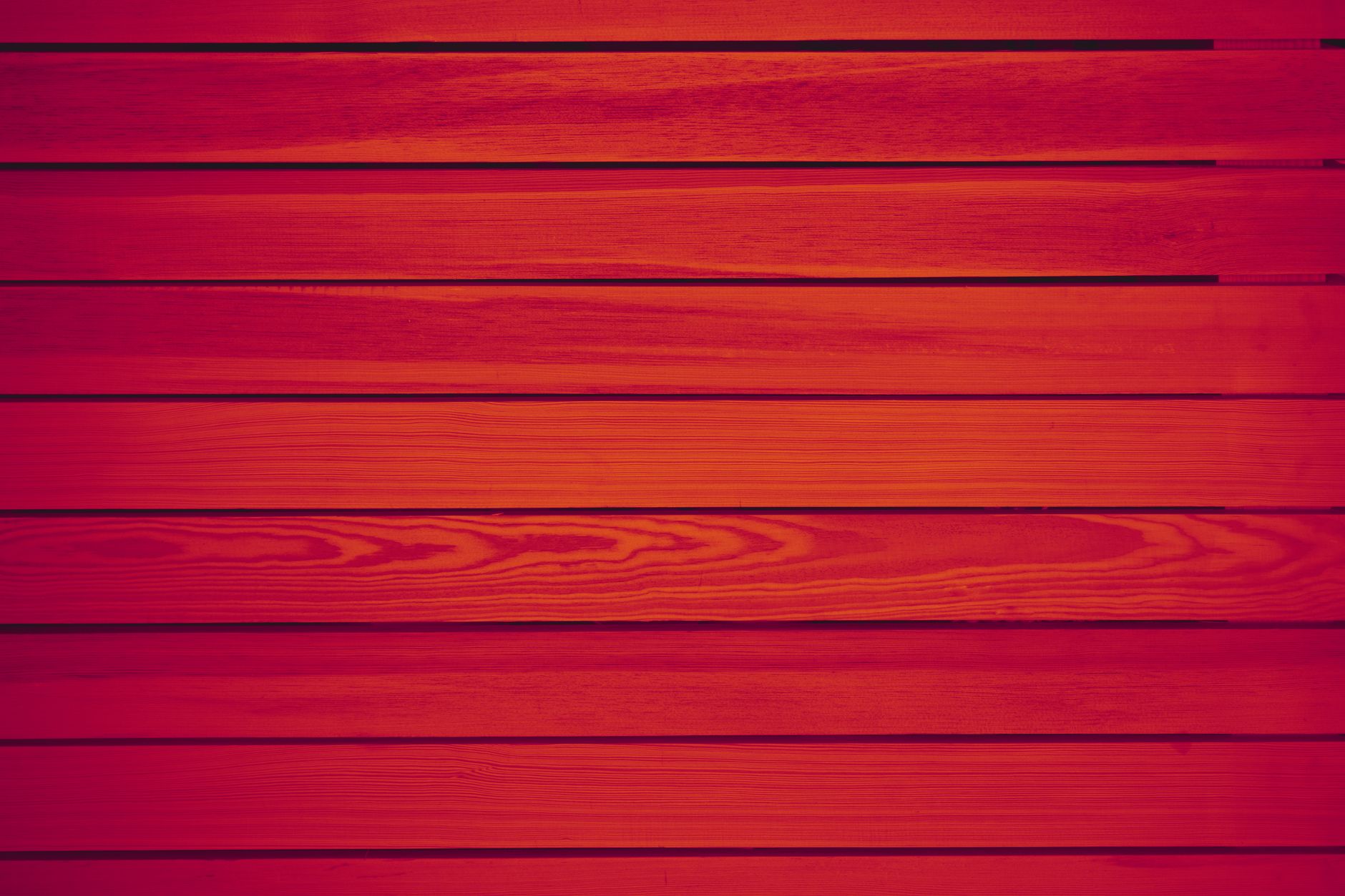 A vivid red wooden wall texture, ideal for backgrounds and design projects.