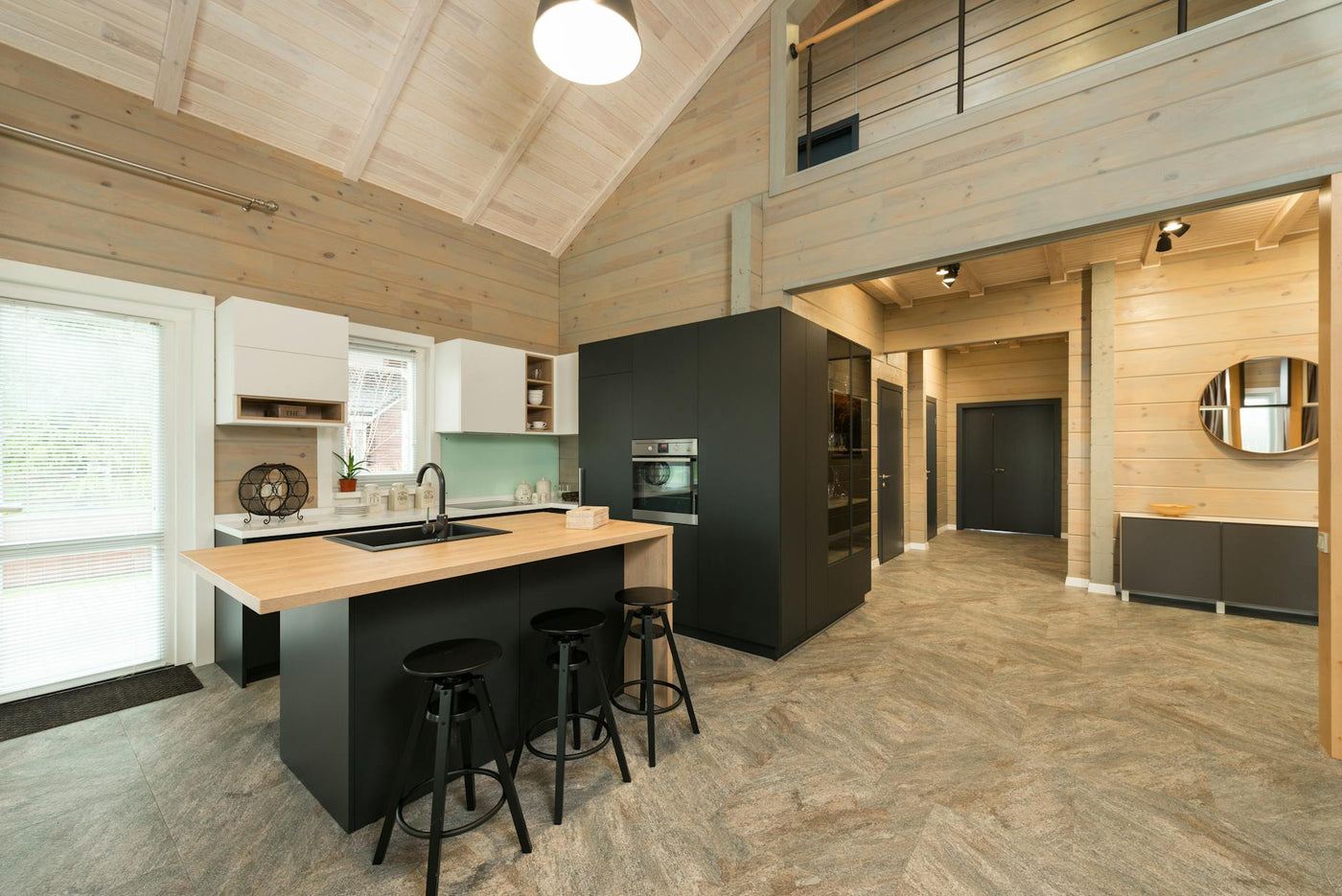 A stylish modern kitchen featuring wooden accents and minimalist design.