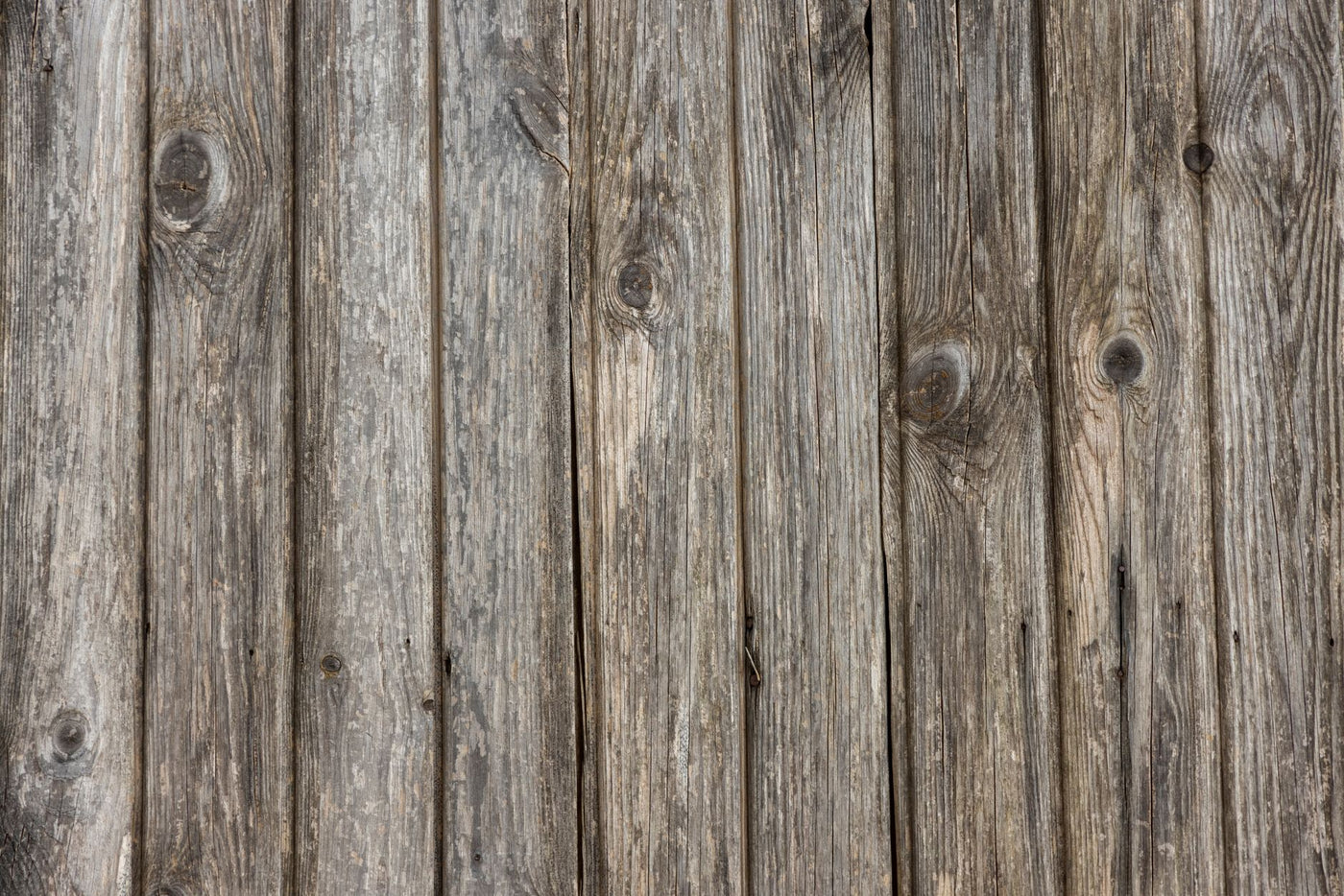 Close-up of a rustic wooden surface showcasing natural grain and texture, ideal for backgrounds or patterns.